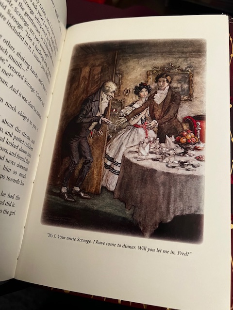 Illustration from Dickens's novella, A Christmas Carol. Scrooge entering his nephew's dining room. Caption: "It is I. Your Uncle Scrooge. I have come to dinner. Will you let me in, Fred?"